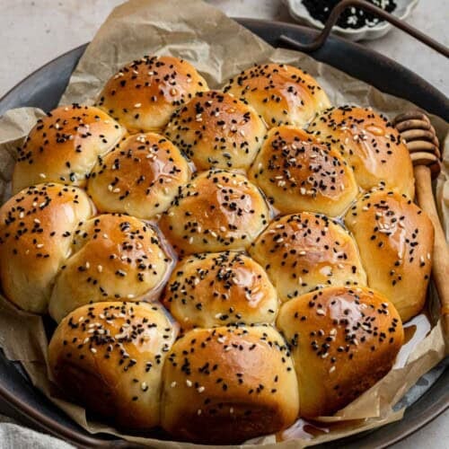 yemeni honeycomb bread, kaliat al nahl, in a tray drizzled with honey