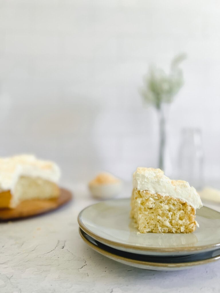 slice of Coconut Cake with toasted shredded coconut and whipped cream cheese frosting