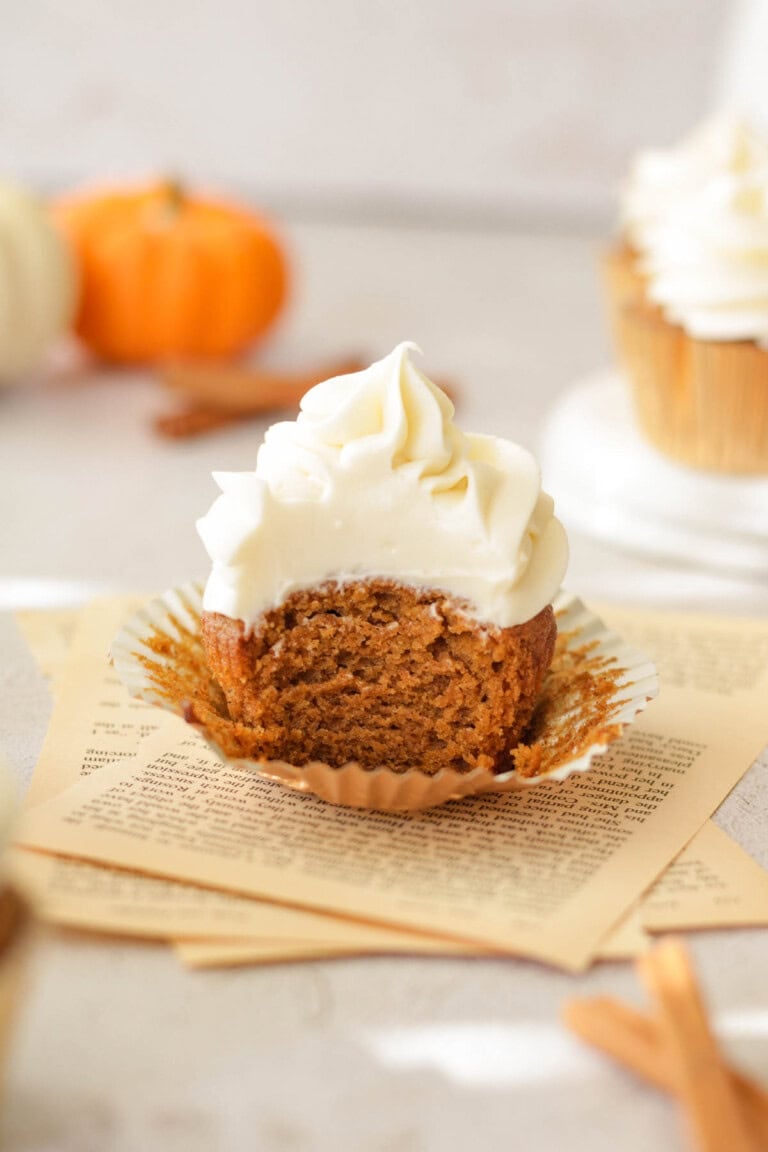 bite of pumpkin cupcake with maple cream cheese frosting
