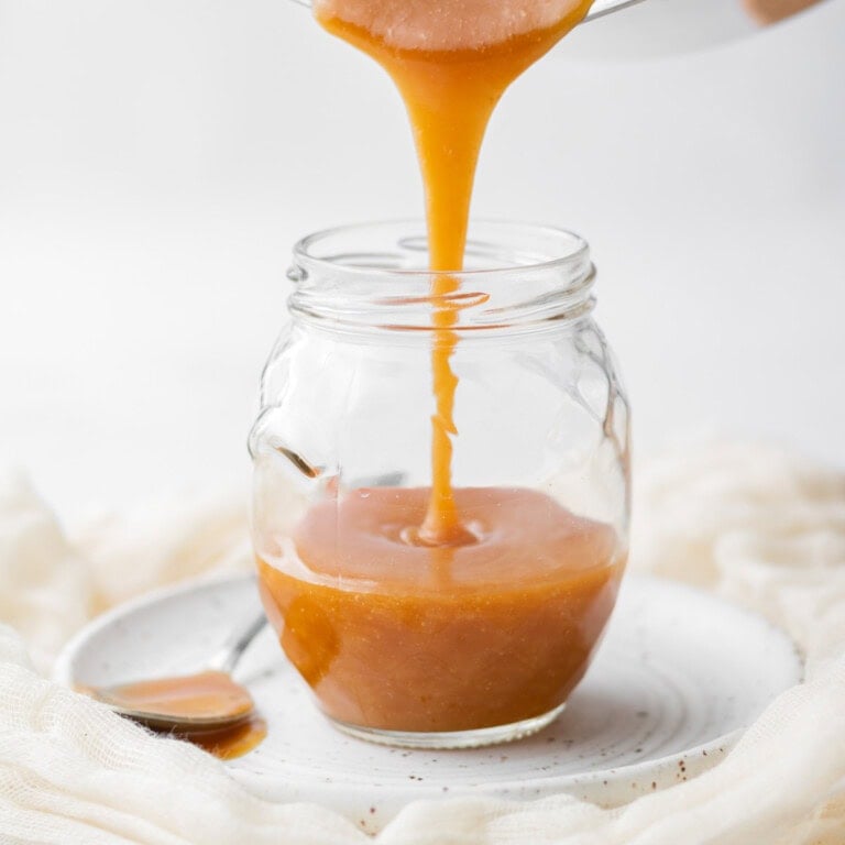 pouring caramel into a jar
