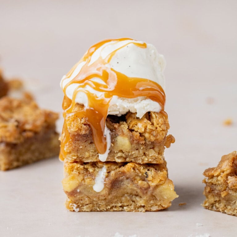 salted caramel apple bars with a scoop of vanilla bean ice cream and a drizzle of homemade caramel sauce