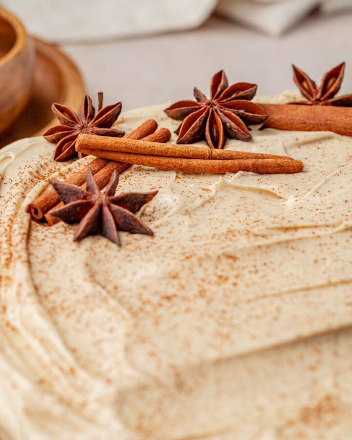 close up of star anise and cinnamon sticks on chai cake