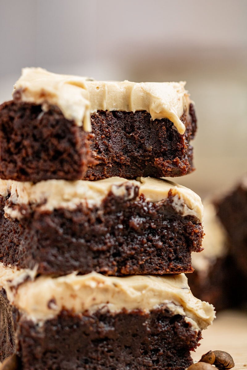 close up of stack of espresso brownies with cream cheese frosting