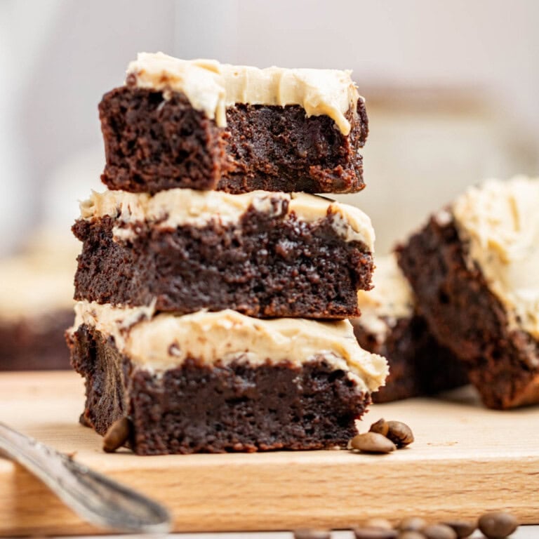 a stack of brownies with cream cheese frosting