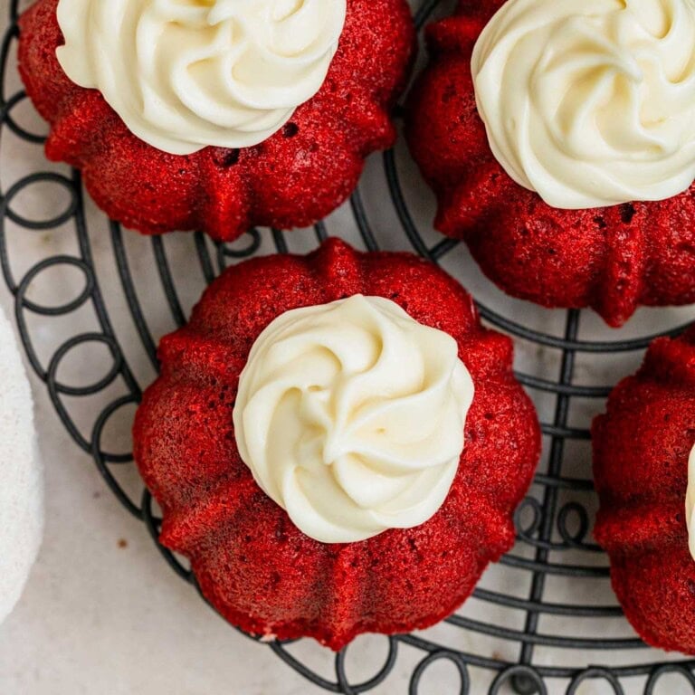 red velvet mini bundt cakes with piped cream cheese frosting