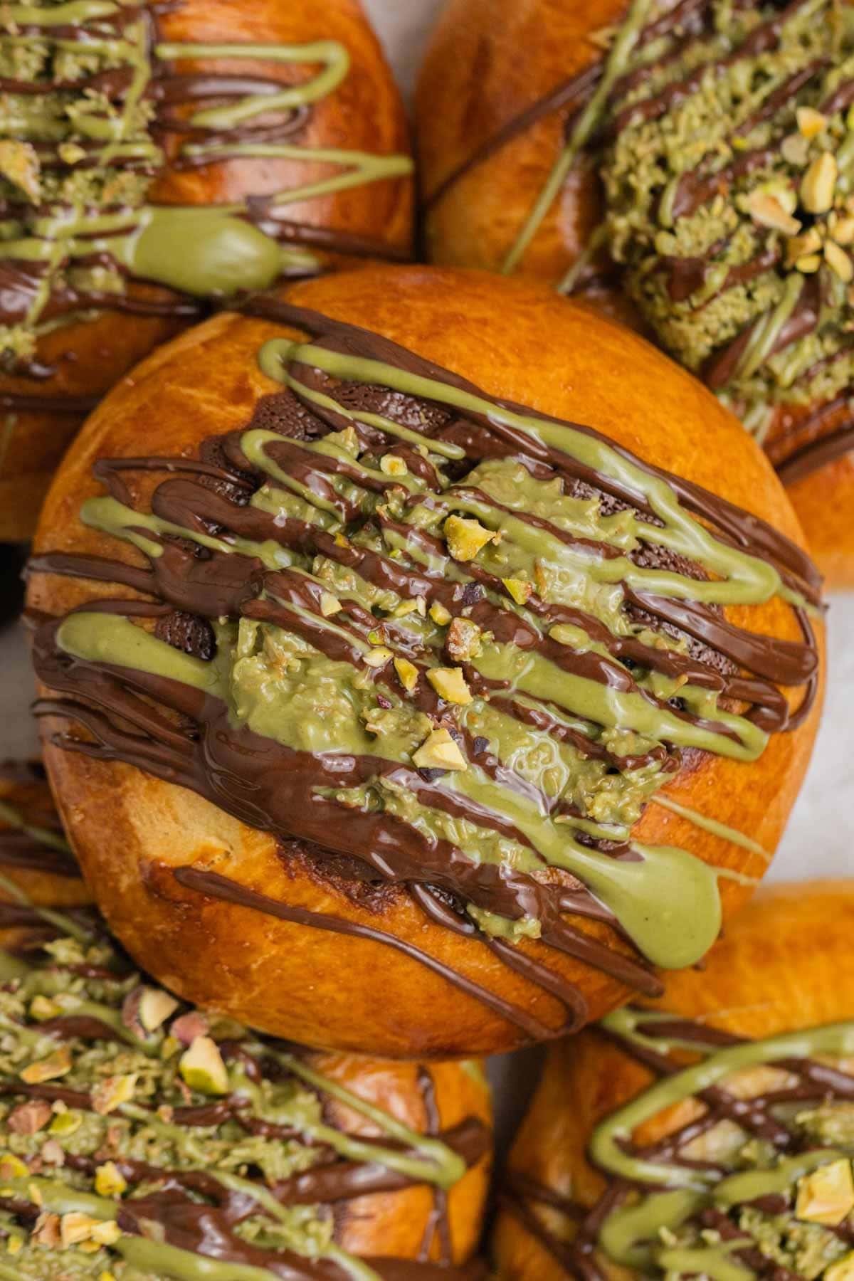 close up of brioche bun topped with pistachio kataifi filling