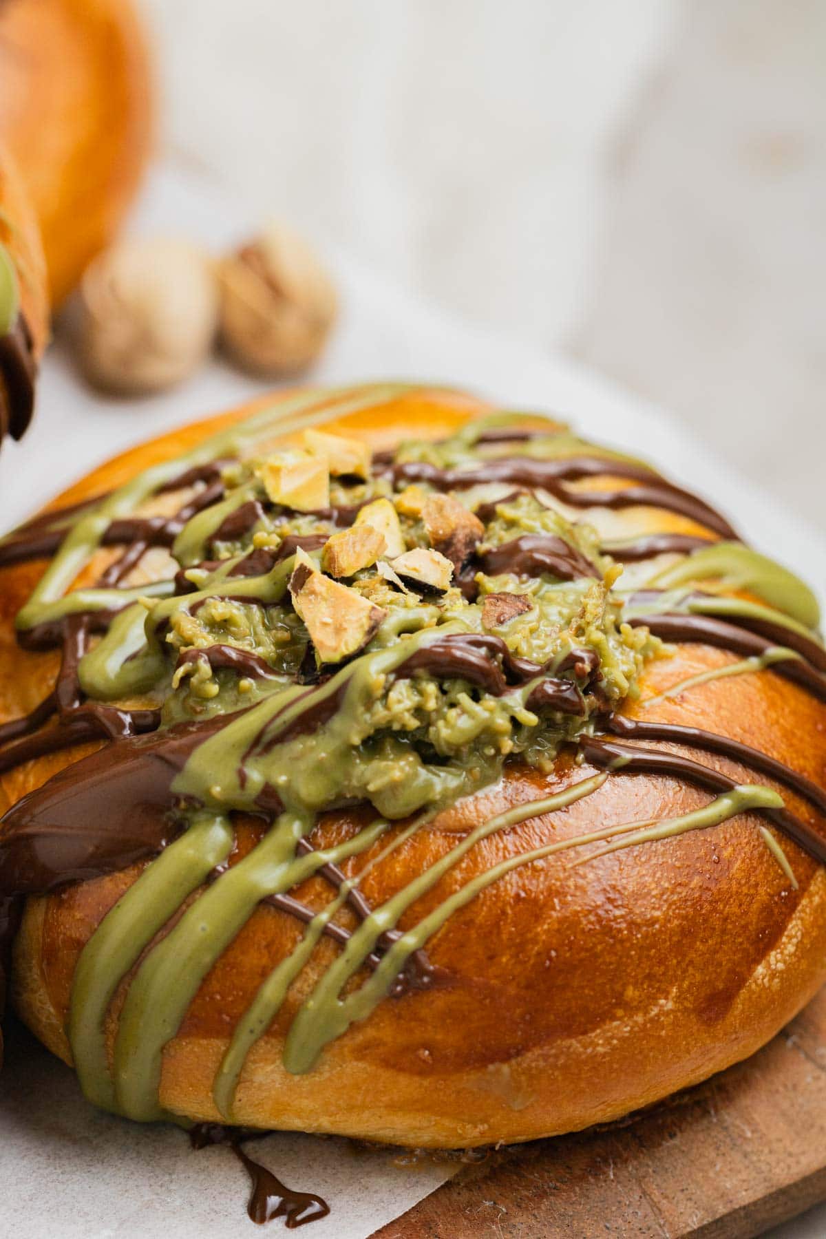 crushed pistachio, melted chocolate and pistachio cream on a brioche bun