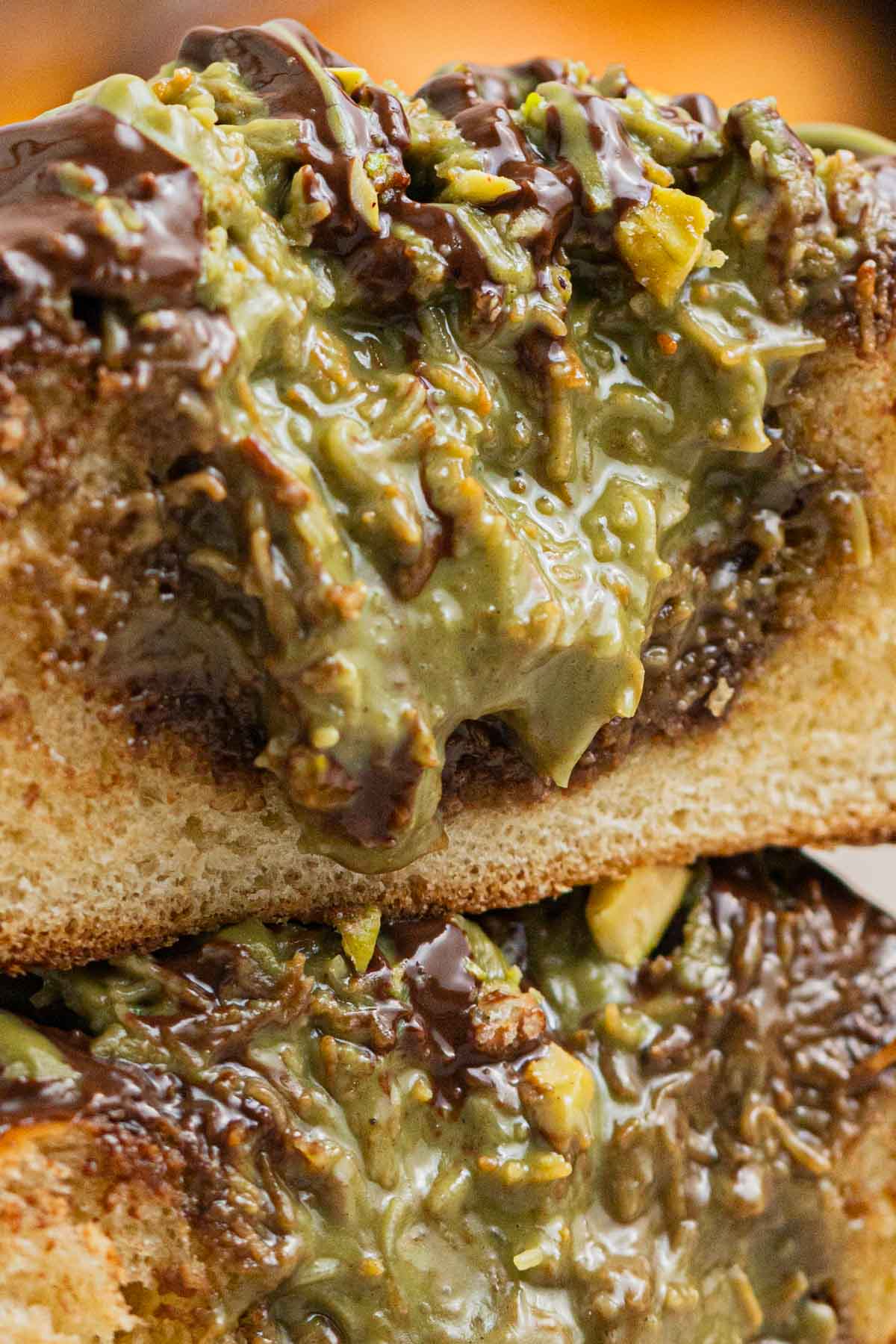 close up shot of pistachio kunafa filling in a brioche bun
