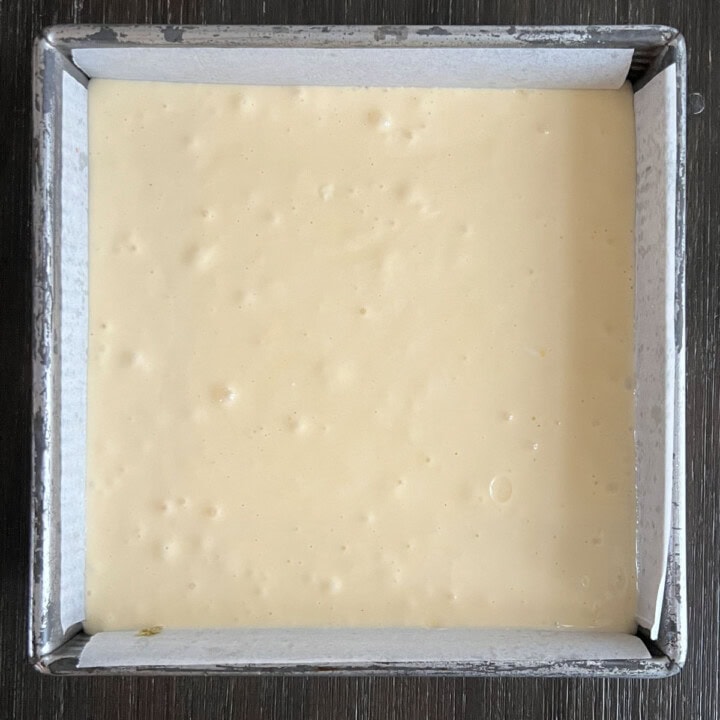 pour cheesecake batter into pan