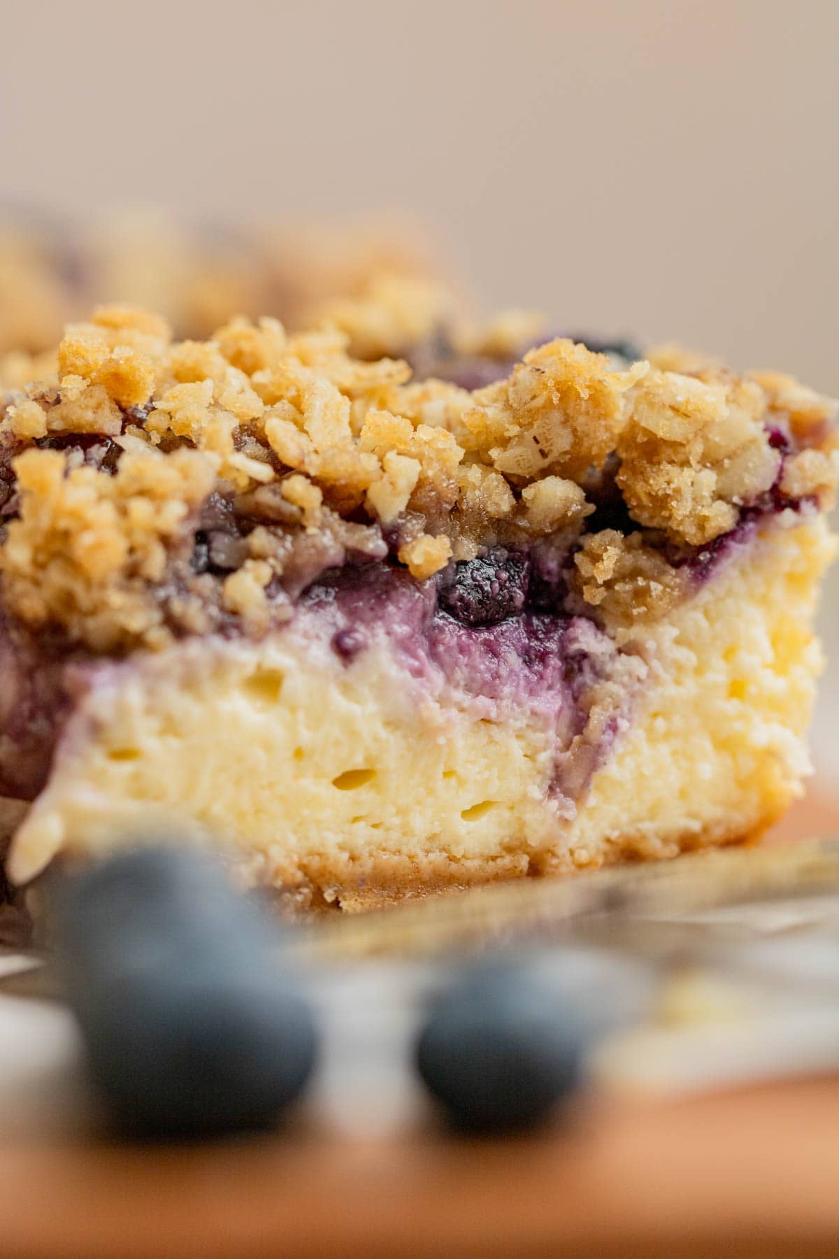 close up of blueberry cheesecake bars with crumble topping