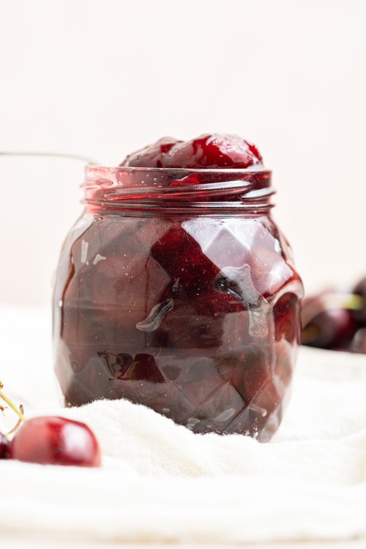 straight on shot of cherry compote in a jar