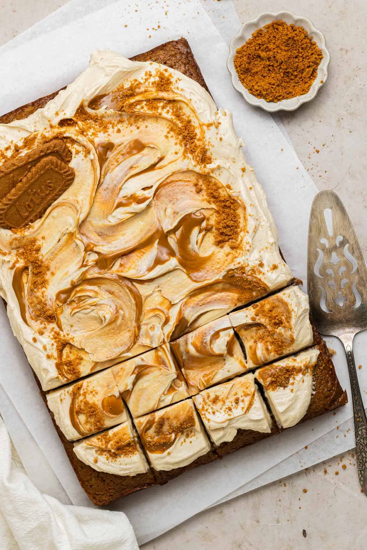 overhead photo of full sheet of banana cake topped with swirls of biscoff cream cheese frosting