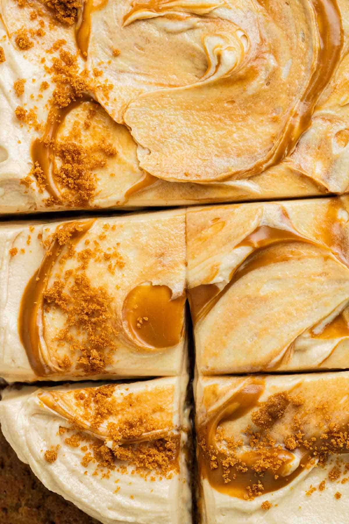 close up of swirls of biscoff cream cheese frosting on top of banana biscoff cake