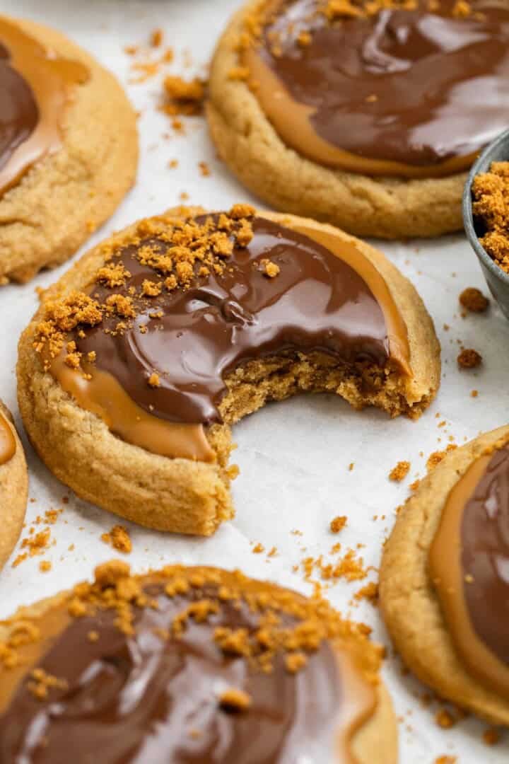 bite taken out of a cookie butter cookie with melted chocolate