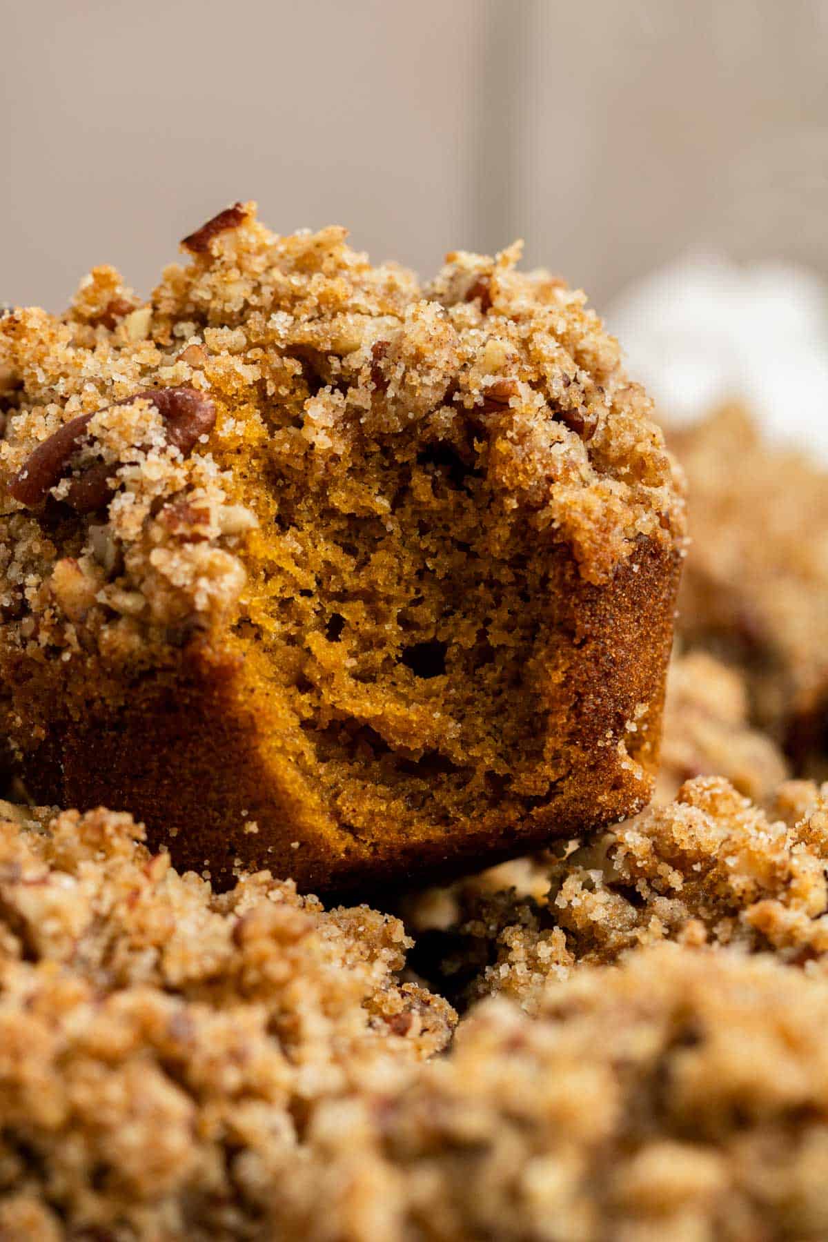 pumpkin muffins with pecan Streusel with a bite taken out of it