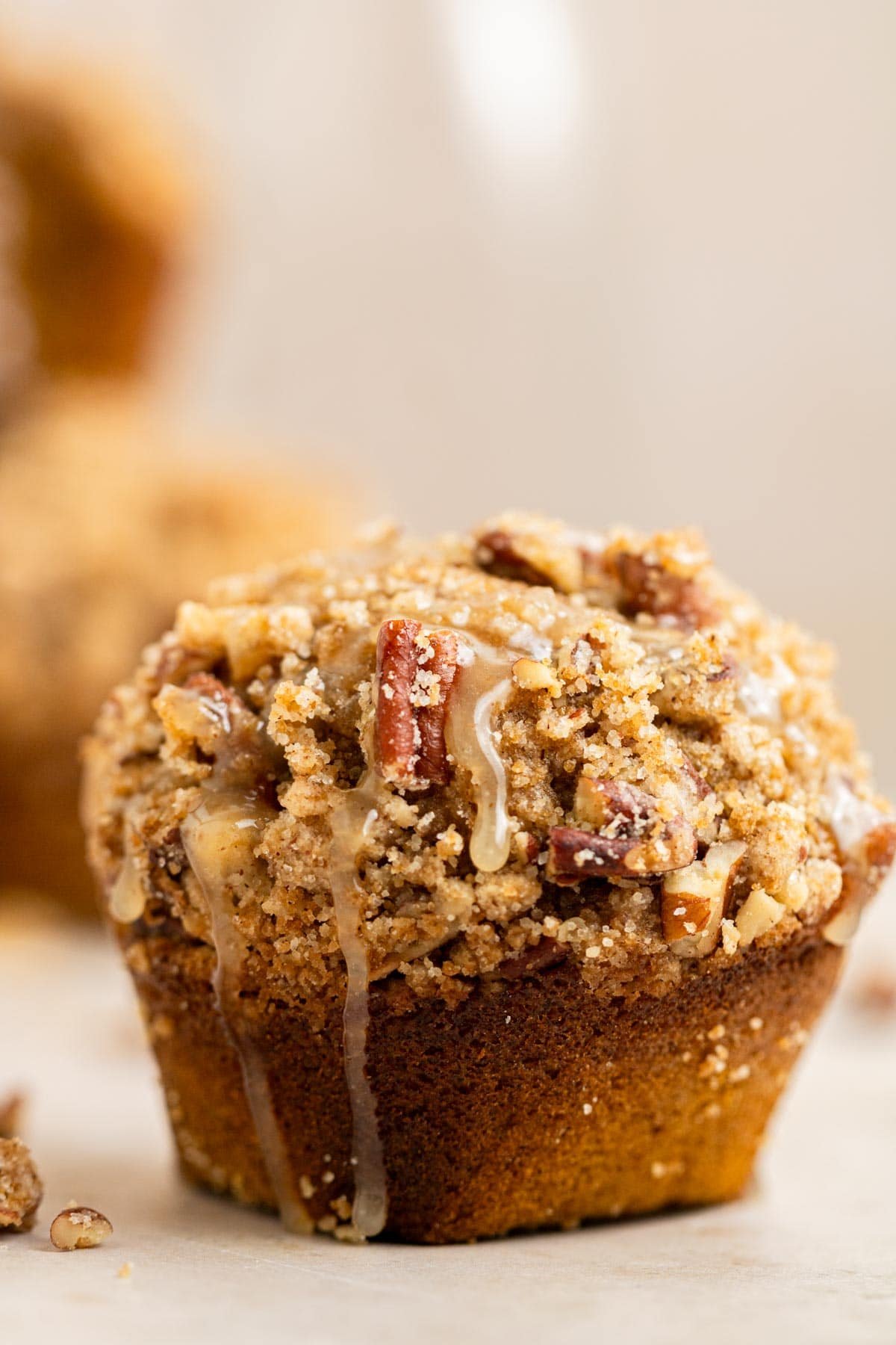 pumpkin muffin with pecan streusel drizzled with maple glaze