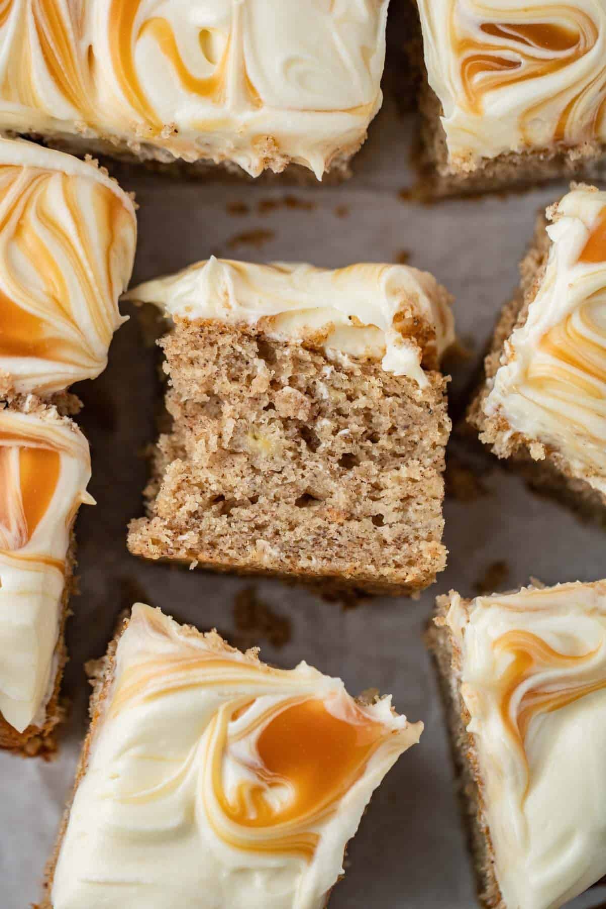banana cake with spices, cream cheese frosting and caramel sauce